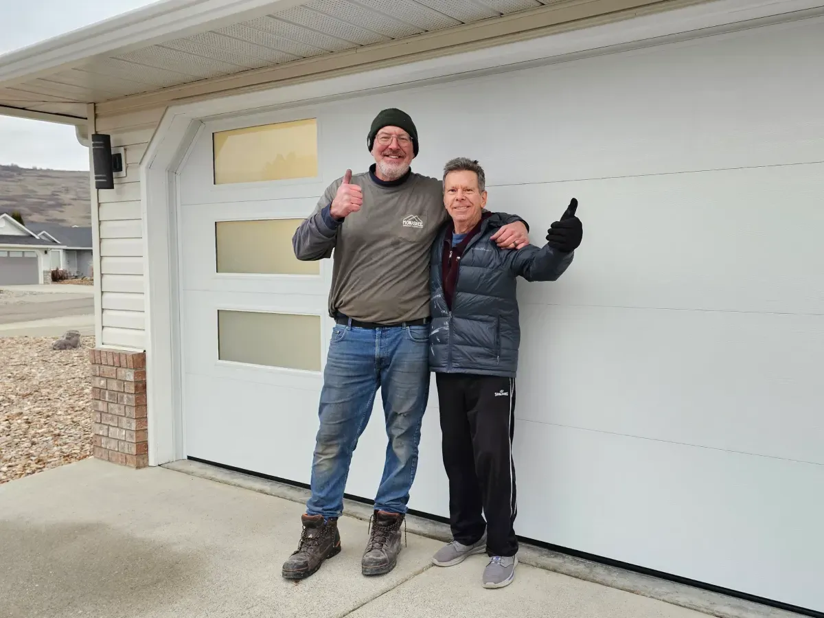 Jeff from Monashee Garage Doors with a customer in front of a new white garage door
